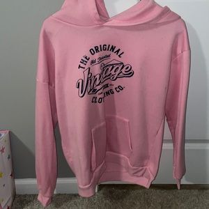 pink hoodie with logo, no stains and soft material.
